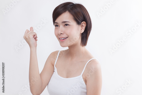 Young beautiful Asian short hair female model on white background