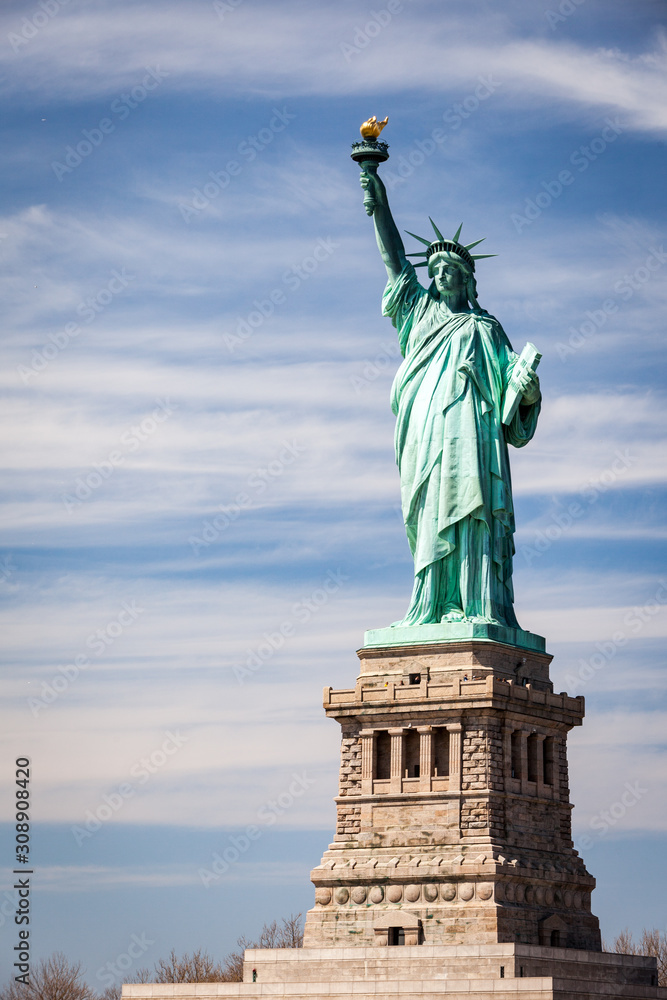 Obraz premium Statue of Liberty, NYC, USA. A view of the familiar New York landmark set against a bright blue spring sky with copy space.