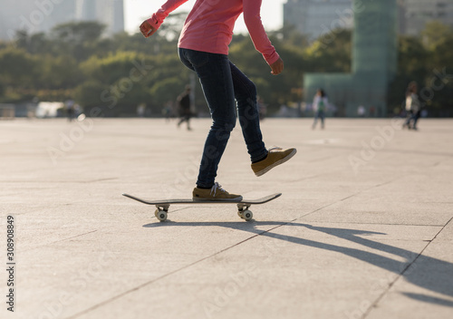 Skateboarder skateboarding at sunset city