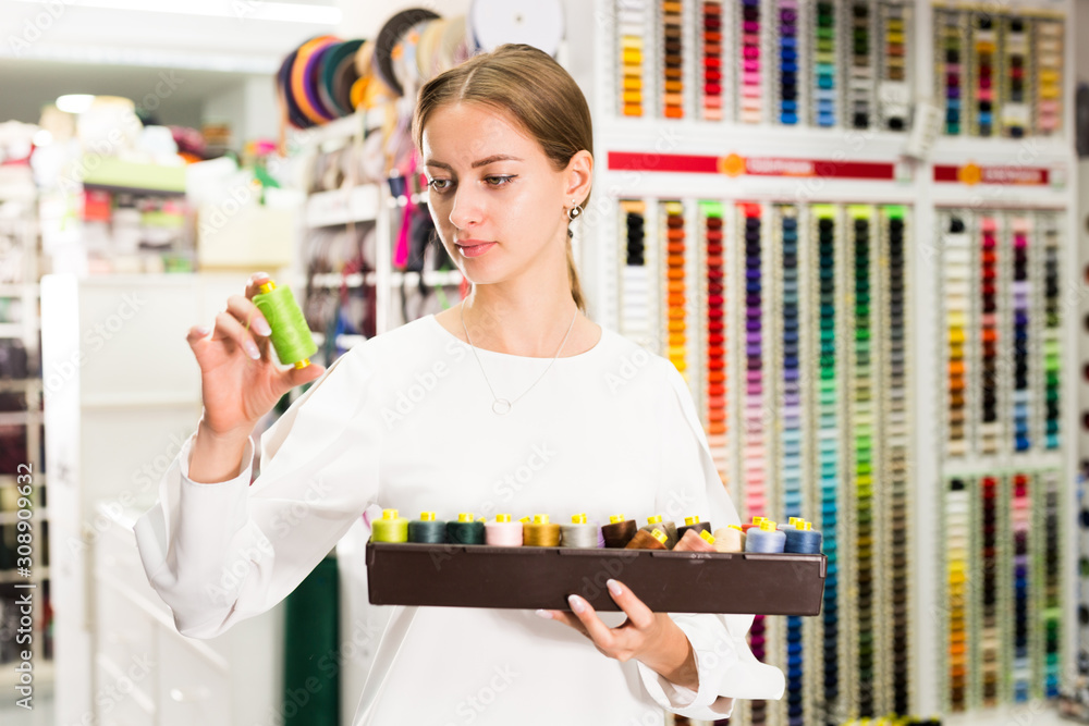 Woman choosing threads for dressmaking