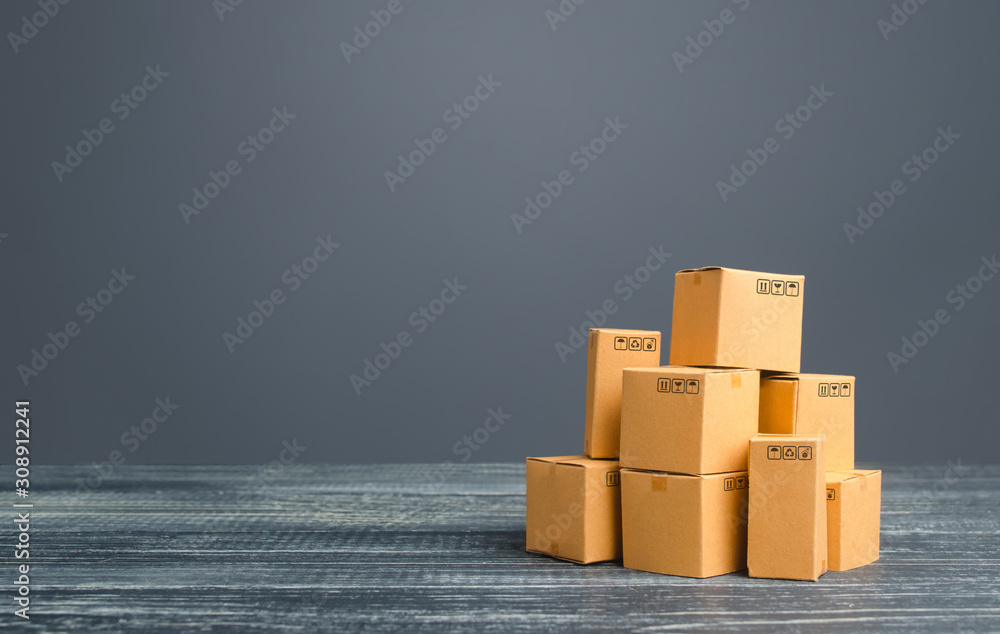 Cardboard boxes pile. Production goods and products, distribution and trade exchange goods, retail sales. Global business, import, export. Freight transportation. Logistics and warehousing. Shipment Cardboard boxes pile. Production goods and products, distribution and trade exchange goods, retail sales. Global business, import, export. Freight transportation. Logistics and warehousing. Shipment