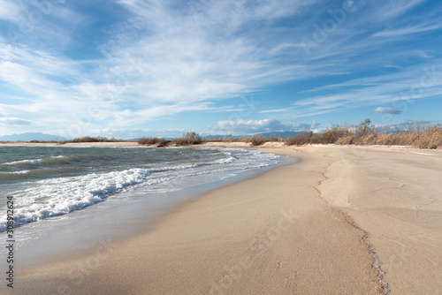 Scenic view on sandy beach and sea at daytime.