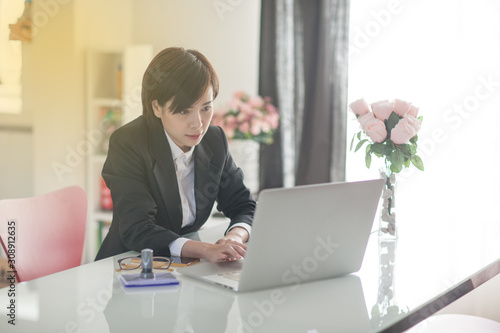 Young Asian short hair female model in formal dress which is good for business purpose