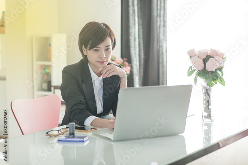 Young Asian short hair female model in formal dress which is good for business purpose