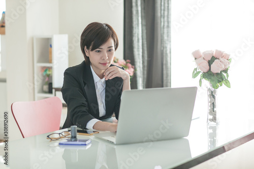 Young Asian short hair female model in formal dress which is good for business purpose