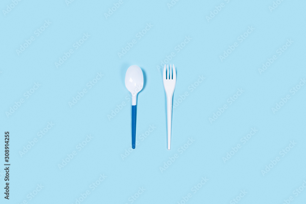 So beautiful and so dangerous plastic spoons. Environmental problem of plastic rubbish pollution. Central composition. So beautiful and so dangerous plastic spoons. Environmental problem of plastic rubbish pollution. Central composition.