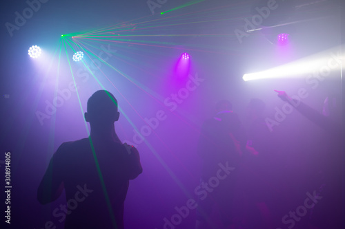 Dancing silhouette lights and Laser dico nightclub photo