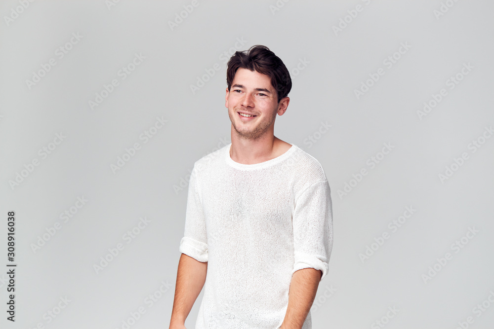 Studio Portrait Of Young Man Wearing White T Shirt Smiling Off Camera Studio Portrait Of Young Man Wearing White T Shirt Smiling Off Camera