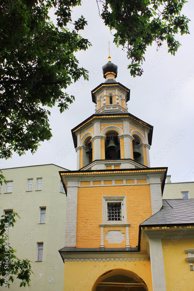 Bell tower view of orthodox church on cloudy summer day. Scenic vertical view of christian church facade in Moscow, Russia 