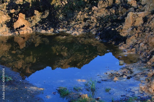 Fototapeta Naklejka Na Ścianę i Meble -  yellow clay is reflected in a puddle