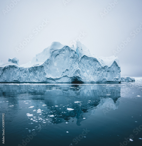Iceberg and ice from glacier in arctic nature landscape in Ilulissat,Greenland. Aerial drone photo of icebergs in Ilulissat icefjord. Affected by climate change and global warming. © Mathias