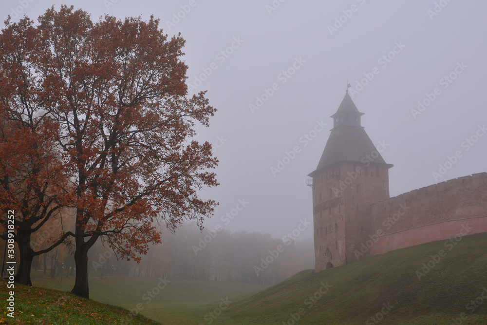 Novgorod Kremlin and autumn trees of the park in the morning fog. Veliky Novgorod