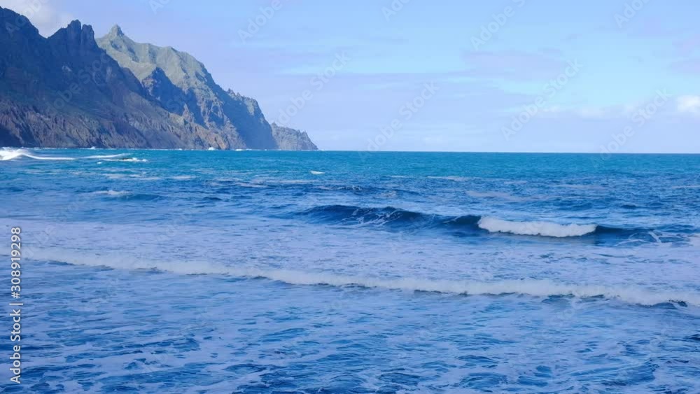 Wonderful endless ocean view with white waves breaking on black beach. Inspiring seascape. Volcanic island of Tenerife. Wonderful endless ocean view with white waves breaking on black beach. Inspiring seascape. Volcanic island of Tenerife.