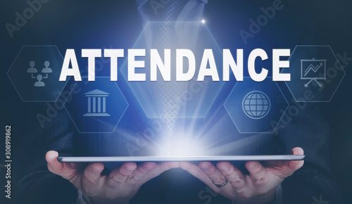 Businessman holding a computer tablet display projecting an Attendance concept.