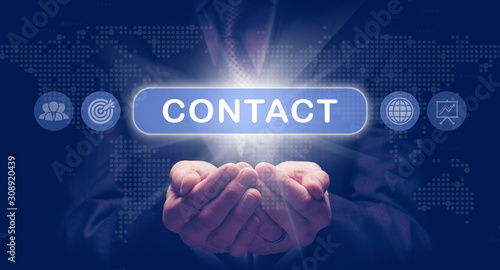 Fotografía Businessmans cupped hands holding a Contact business concept on a computerised display