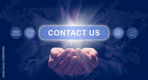 Fotografía Businessmans cupped hands holding a Contact Us business concept on a computerised display