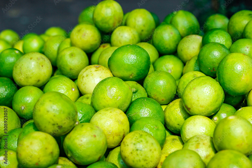 Green and yellow lemon in indian vegetable market Green and yellow lemon in indian vegetable market