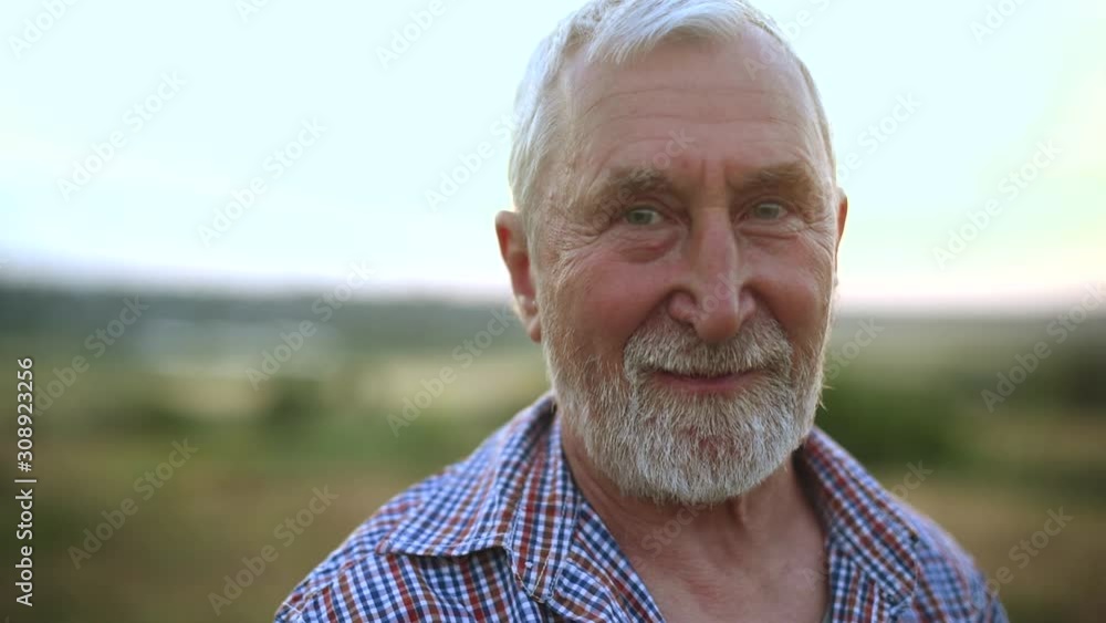 Gray-haired man with a beard in the field Gray-haired man with a beard in the field