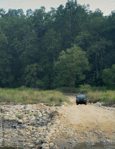 Tourist in jeep navigating the forest of the Jim Corbett national reserve