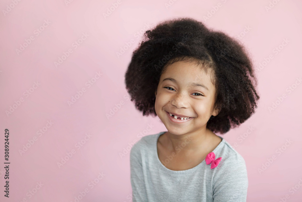 Happy adorable african american child girl isolated on pastel