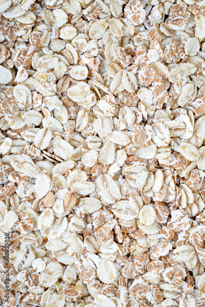 Heap of oat flakes, texture of uncooked flake. Diet food concept. Background of raw oatmeal. Carbohydrates product. Heap of oat flakes, texture of uncooked flake. Diet food concept. Background of raw oatmeal. Carbohydrates product.
