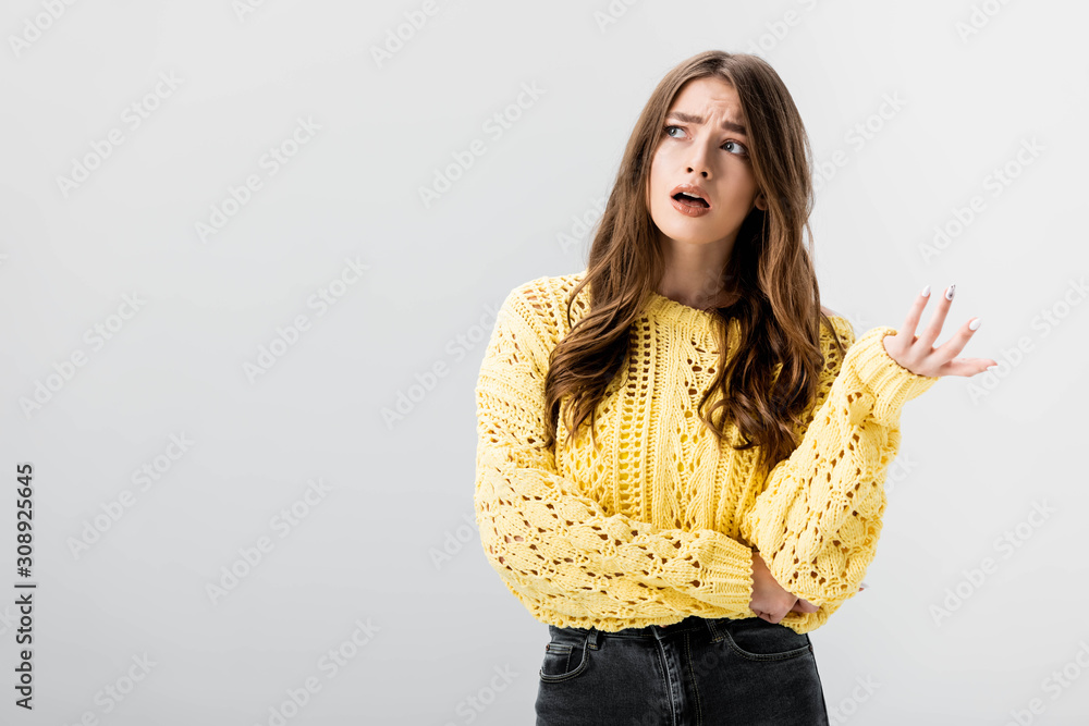 disappointed girl showing indignation gesture while looking away isolated on grey disappointed girl showing indignation gesture while looking away isolated on grey