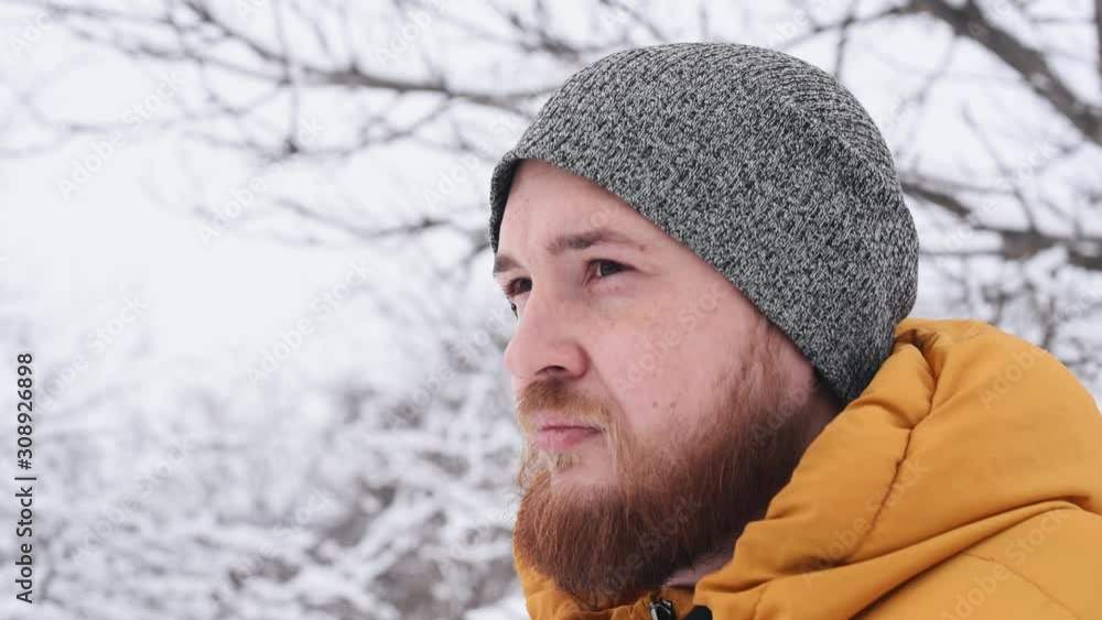 Handsome man with red beard in hat and yellow coat in winter time. Handsome man with red beard in hat and yellow coat in winter time.