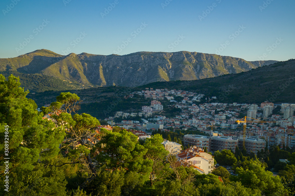 Panoramic view to the town at the foot of the mountains