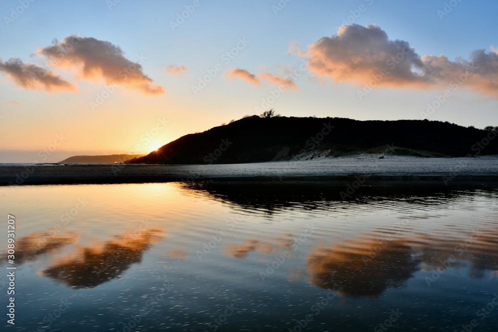 Fototapeta premium Sunset at Three Cliffs Bay, The Gower Peninsula, South Wales, U.K.
