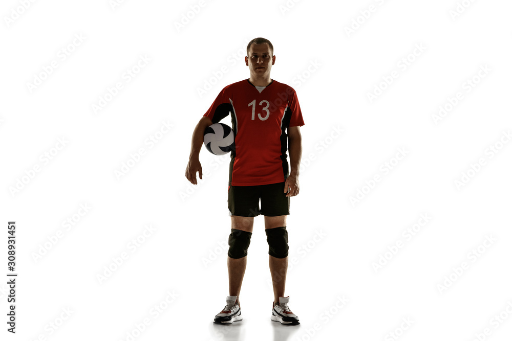 Young caucasian volleyball player placticing on white background. Male sportsman posing confident with the ball, prepared for win. Sport, healthy lifestyle, activity, movement concept. Copyspace.