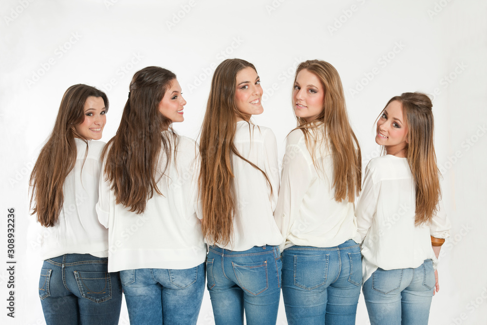 Group of happy girls turning their heads back to camera Group of happy girls turning their heads back to camera