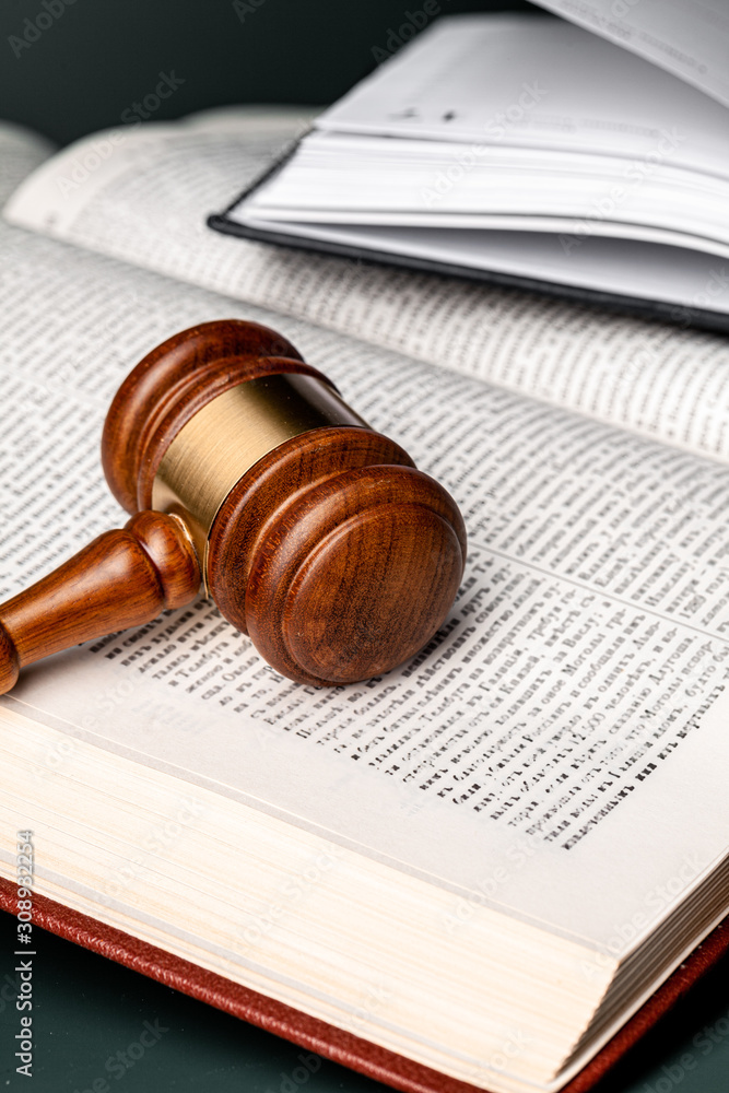 Close up of a brown wooden gavel and book Close up of a brown wooden gavel and book