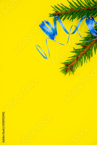Fir branches and bright streamers on a yellow background.