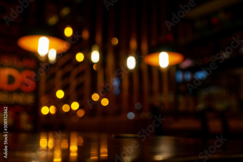 Blurred background in modern cafe, bokeh of lights.