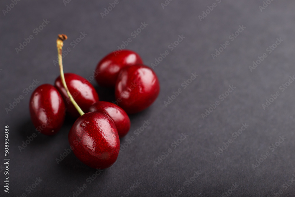 Ugly weird red sweet cherry on black background. side view. food concept. Ugly weird red sweet cherry on black background. side view. food concept.