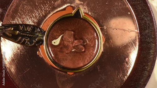 wax melt and stamp pour from wax, close up from above, soft focus