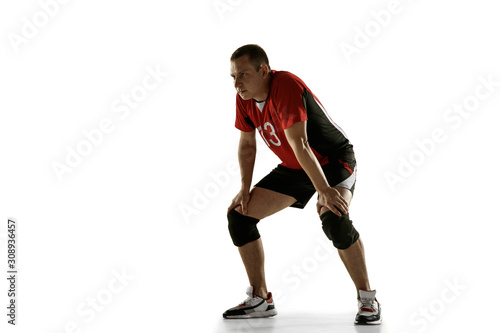 Young caucasian volleyball player placticing isolated on white background. Male sportsman training with the ball in motion and action. Sport, healthy lifestyle, activity, movement concept. Copyspace.