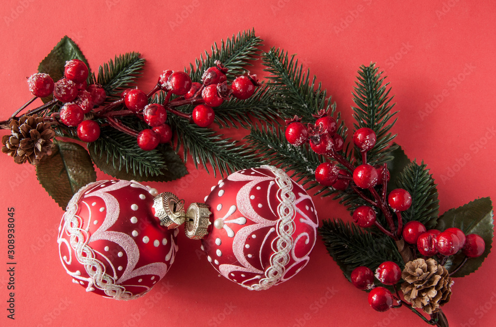 many red christmas balls on red background with copy space. New Year greeting card.