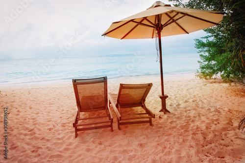 Fototapeta Naklejka Na Ścianę i Meble -  Two beach chairs on tropical vacation, relax at sea