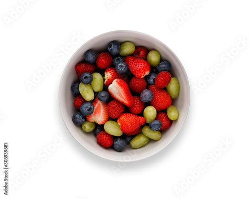 A bowl full of delicious fresh summer fruits, isolated on white
