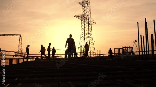silhouette the group of workers working at a construction site.Construction workers work in preparation for binding rebar and concrete work