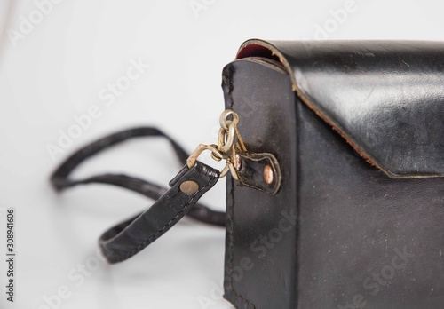 London, England, 29/11/19 Vintage retro leather camera bag with a metal locking mechanism shot isolated on a white background used for a print T3 old camera carry case.