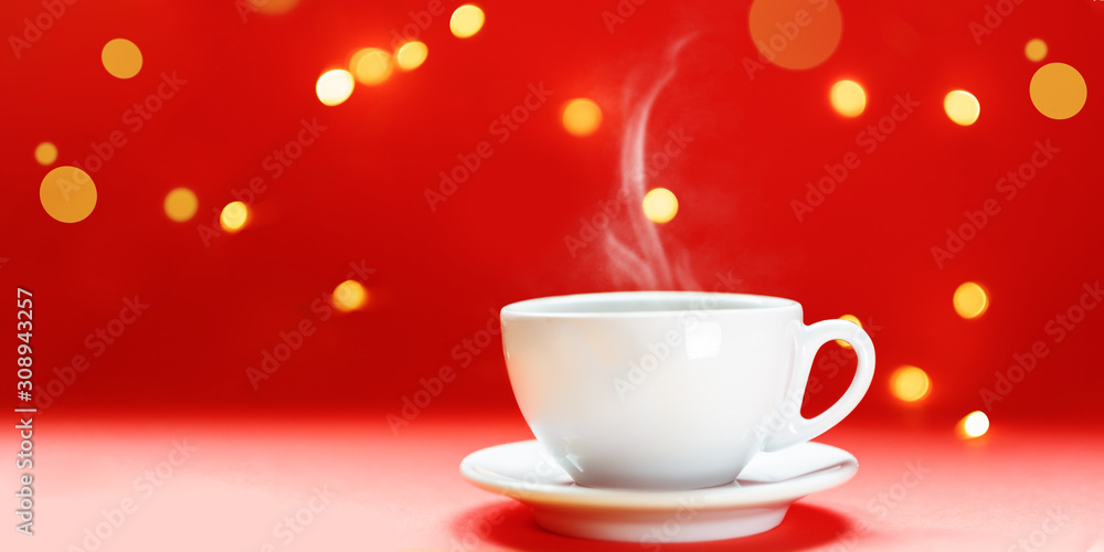 Steaming coffee cup over red background. Festive atmosphere with warm bokeh lights Steaming coffee cup over red background. Festive atmosphere with warm bokeh lights
