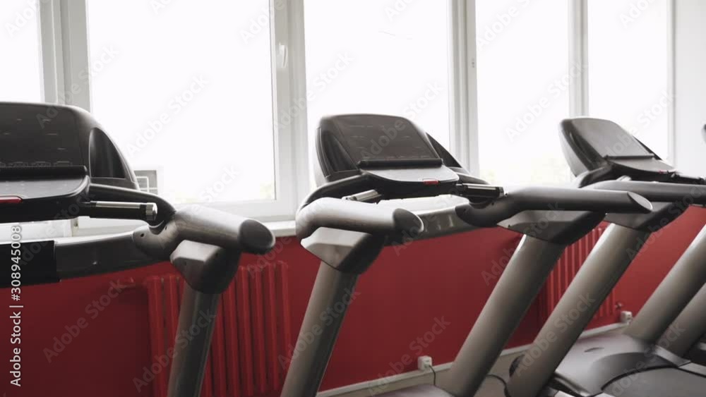 Treadmill machine in modern and empty cardio zone Treadmill machine in modern and empty cardio zone