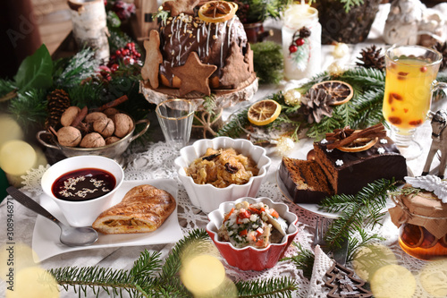 Fotografia Christmas Eve table with traditional dishes and cakes
