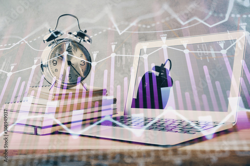 Financial chart drawing and table with computer on background. Double exposure. Concept of international markets.