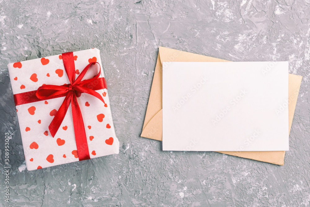Envelope Mail with Red Heart and gift box over grey cement Background. Valentine Day Card, Love or Wedding Greeting Concept Envelope Mail with Red Heart and gift box over grey cement Background. Valentine Day Card, Love or Wedding Greeting Concept