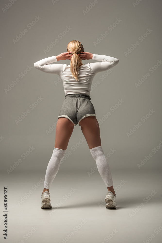 back view of young sexy girl in shorts twerking on white background foto de  Stock | Adobe Stock