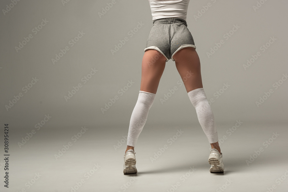 back view of young sexy girl in shorts twerking on white background foto de  Stock | Adobe Stock