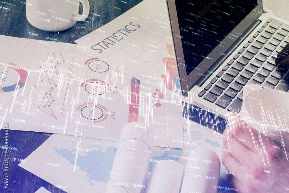 Double exposure of businessman's hands with laptop and stock market graph background. Concept of research and trading. Double exposure of businessman's hands with laptop and stock market graph background. Concept of research and trading.